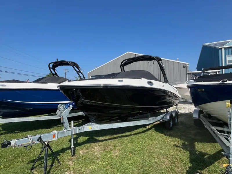 Slide: The Image of 2025 Bayliner VR6 Bowrider OB on trailer, parked outdoors under clear blue sky. - 3