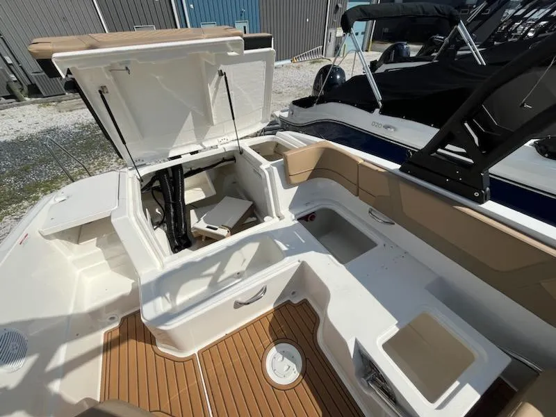 Slide: The Image of 2025 Bayliner VR6 Bowrider OB interior with open storage compartments and seating. - 7