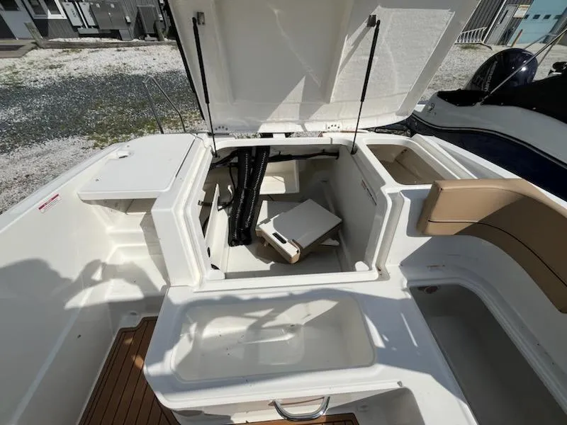 Slide: The Image of 2025 Bayliner VR6 Bowrider OB open storage compartments, showcasing spacious interior design. - 8
