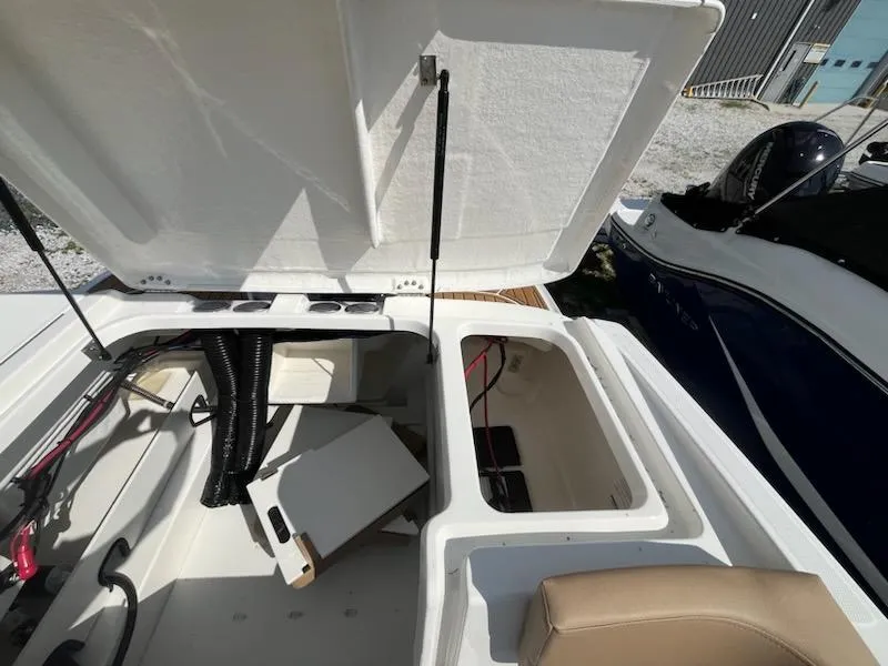 Slide: The Image of 2025 Bayliner VR6 Bowrider OB open storage compartments, showcasing interior details and design. - 9