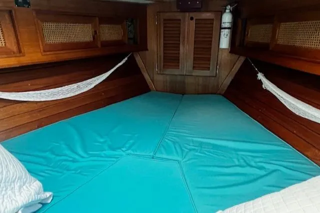 Slide: The Image of Cozy cabin interior of 1981 Bristol 35.5 sailboat with blue bedding and wooden accents. - 11
