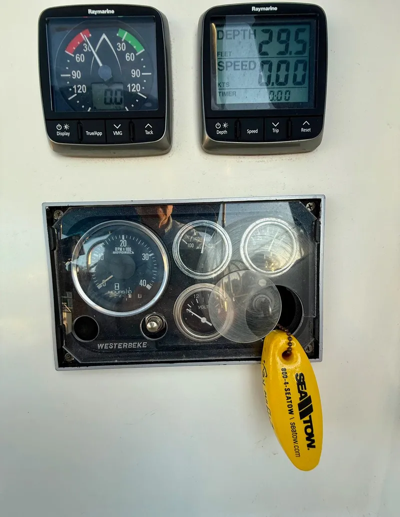 Slide: The Image of Control panel of a 1981 Bristol 35.5 sailboat with Raymarine instruments and Sea Tow key tag. - 16