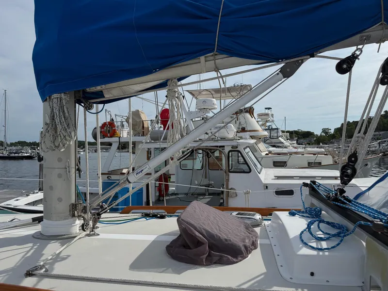 Slide: The Image of Sailboat deck with blue cover, docked in marina; Bristol 35.5, 1981 model. - 22
