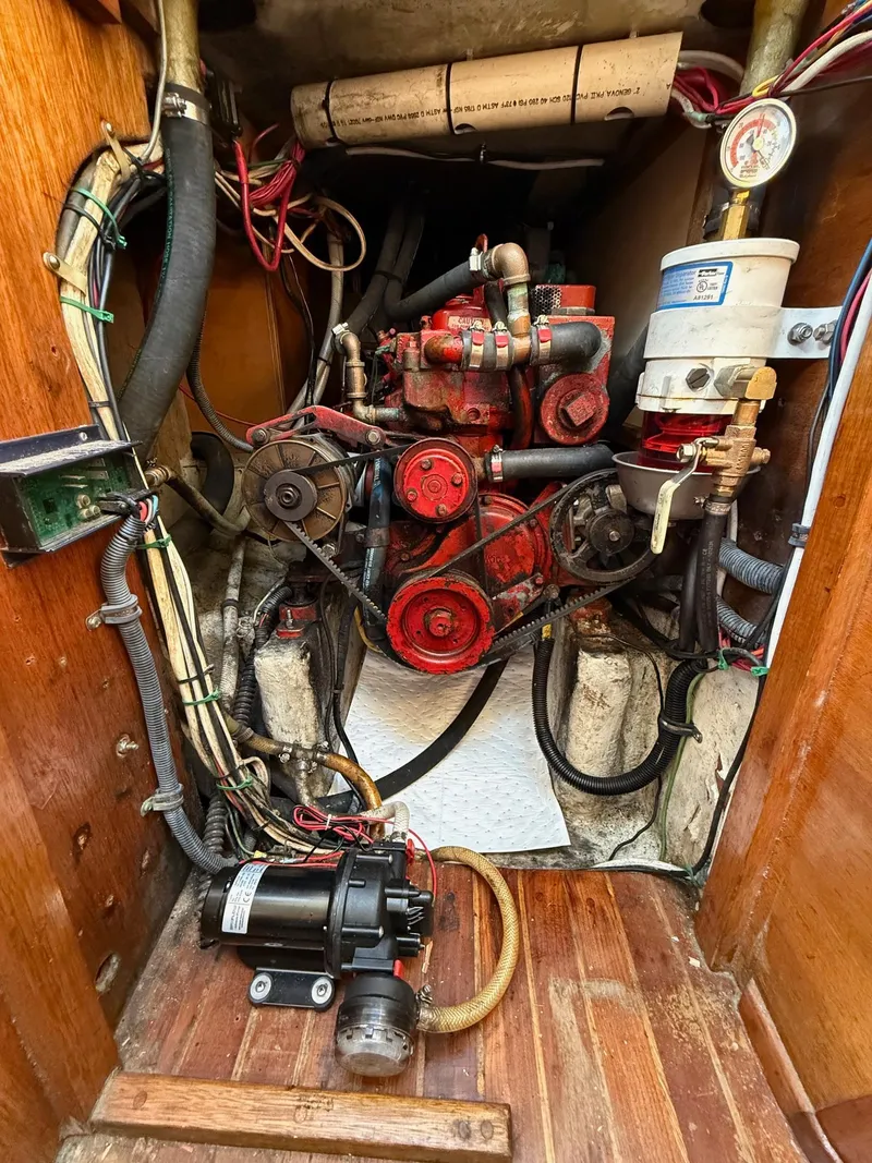 Slide: The Image of 1981 Bristol 35.5 engine compartment with red motor, wiring, and components. - 26