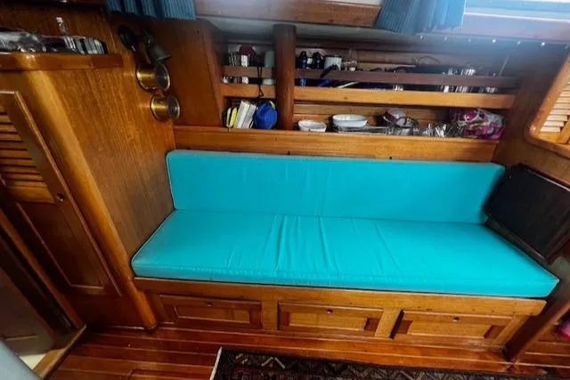 Slide: The Image of 1981 Bristol 35.5 interior with turquoise seating and wooden cabinetry. - 5
