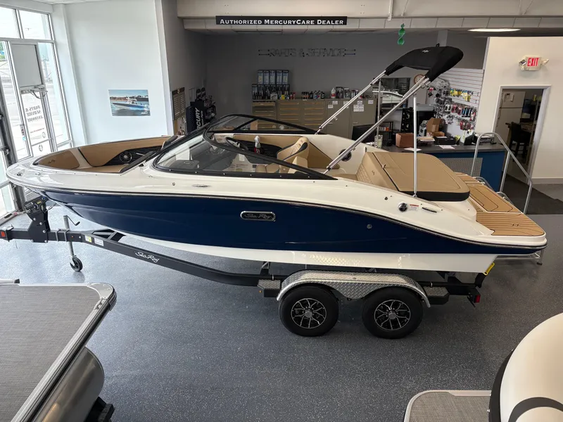 Slide: The Image of 2025 Sea Ray SPX 190 boat displayed indoors on a trailer. - 2