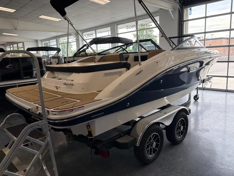 Slide: The Image of 2025 Sea Ray SPX 190 boat on trailer in showroom, featuring sleek design and modern amenities. - 3
