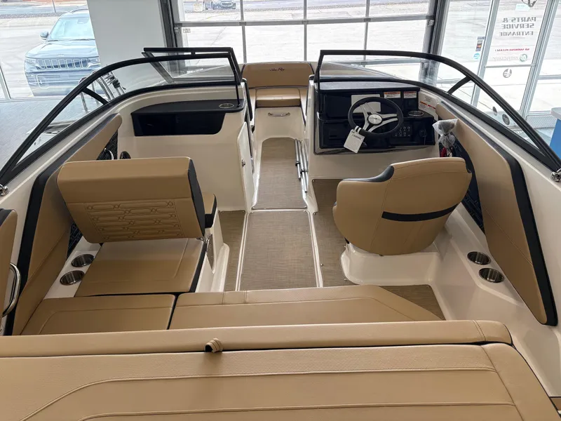 Slide: The Image of 2025 Sea Ray SPX 190 boat interior with tan seating and modern dashboard. - 5