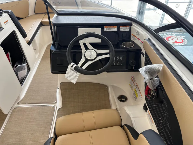 Slide: The Image of Interior view of 2025 Sea Ray SPX 190 boat, featuring steering wheel and dashboard controls. - 7
