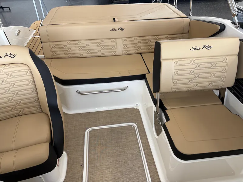 Slide: The Image of 2025 Sea Ray SPX 190 boat interior with beige seating and elegant design. - 8