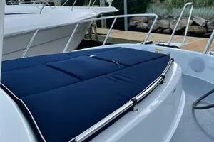 Slide: The Image of 2022 Targa 32 boat with blue deck cover, docked at marina. - 10