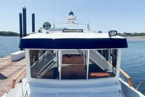 Slide: The Image of 2022 Targa 32 boat docked, showcasing cabin and sleek design. - 12