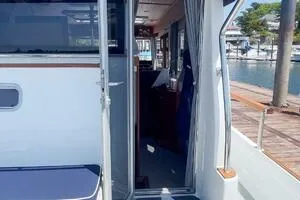 Slide: The Image of 2022 Targa 32 boat interior view with open door, dockside setting. - 13