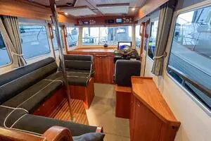 Slide: The Image of Interior of 2022 Targa 32 boat with wood finish and black seating. - 14