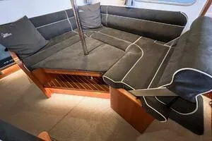 Slide: The Image of 2022 Targa 32 interior with black cushioned seating and wooden accents. - 16