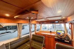 Slide: The Image of Interior of 2022 Targa 32 boat with wooden finish and modern navigation equipment. - 18