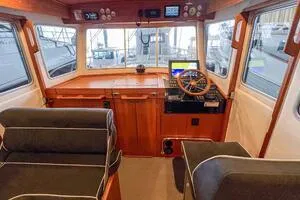 Slide: The Image of Interior of 2022 Targa 32 boat with wooden dashboard and modern navigation equipment. - 19