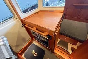 Slide: The Image of Interior of 2022 Targa 32 boat with wooden cabinetry and compact design. - 21
