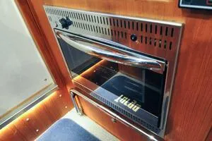 Slide: The Image of 2022 Targa 32 interior with modern stainless steel oven and wooden paneling. - 23