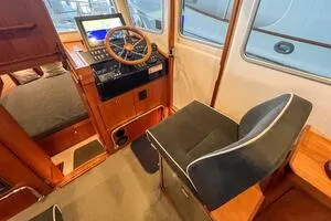 Slide: The Image of Interior of 2022 Targa 32 boat with steering wheel and navigation controls. - 24