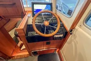 Slide: The Image of 2022 Targa 32 boat helm with wooden steering wheel and navigation display. - 26