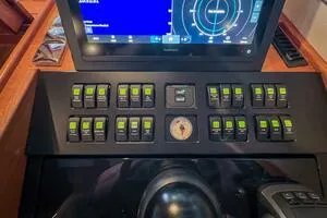 Slide: The Image of Control panel of 2022 Targa 32 boat with switches and navigation display. - 28