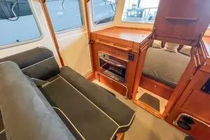 Slide: The Image of Interior of 2022 Targa 32 boat with seating, wood finish, and windows. - 32