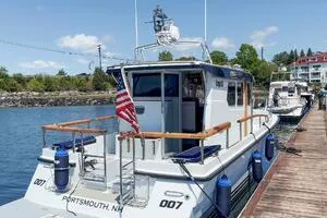 Slide: The Image of Targa 32 boat docked, displaying American flag, Portsmouth, NH, 2022 model. - 4