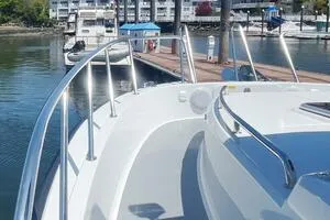 Slide: The Image of 2022 Targa 32 boat docked at marina with sleek design and stainless steel railings. - 8
