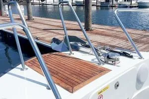 Slide: The Image of 2022 Targa 32 boat docked at marina with wooden deck and metal railings. - 9