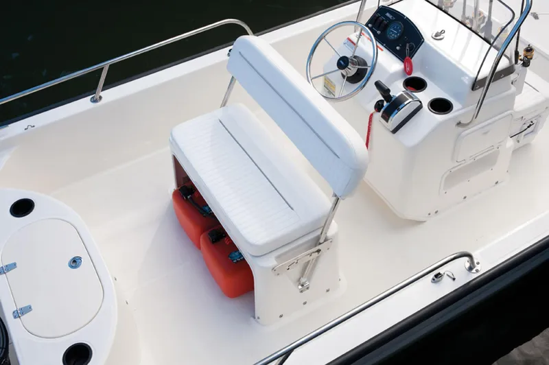 Slide: The Image of Manufacturer Provided Image: 2016 Boston Whaler 150 Montauk boat interior with seating and steering console. - 18