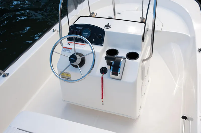 Slide: The Image of Manufacturer Provided Image: 2016 Boston Whaler 150 Montauk boat console with steering wheel and controls. - 19