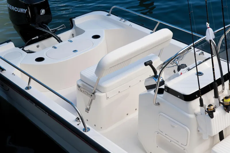 Slide: The Image of Manufacturer Provided Image: 2016 Boston Whaler 150 Montauk boat interior with seating and fishing rods. - 20