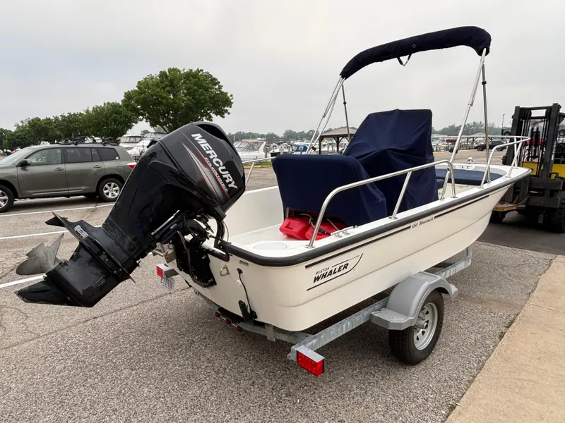Slide: The Image of 2016 Boston Whaler 150 Montauk boat on trailer with Mercury outboard motor. - 7