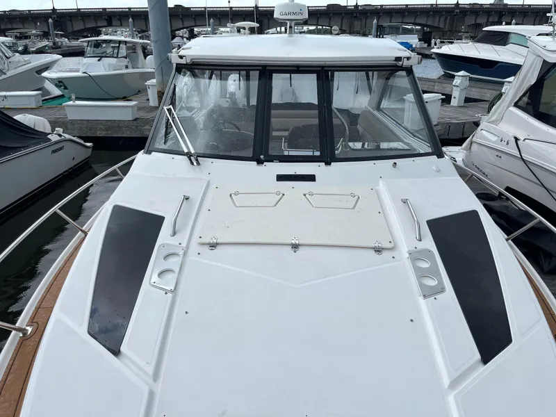 Slide: The Image of 2014 Regal 35 Sport Coupe docked at marina, front deck view. - 14