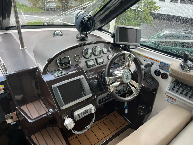 Slide: The Image of 2014 Regal 35 Sport Coupe cockpit with steering wheel, navigation screens, and control panel. - 17
