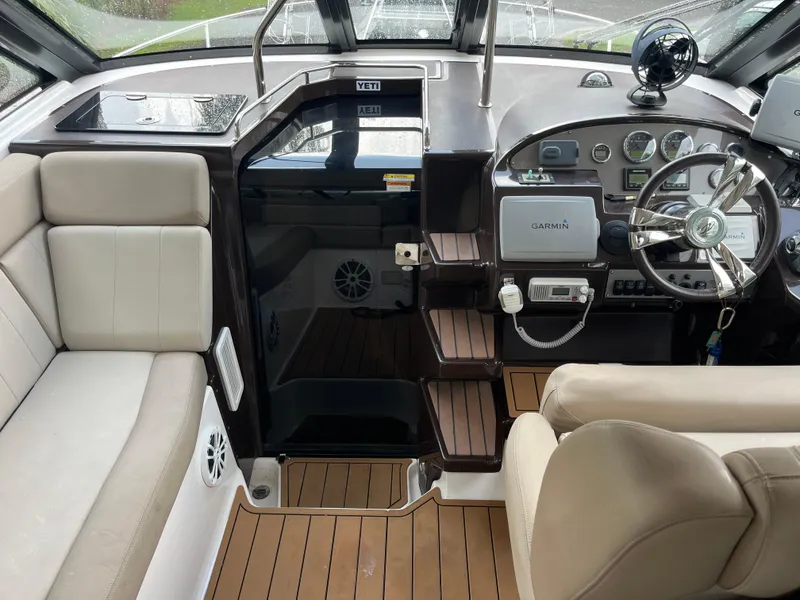 Slide: The Image of 2014 Regal 35 Sport Coupe cockpit with Garmin navigation and beige seating. - 19