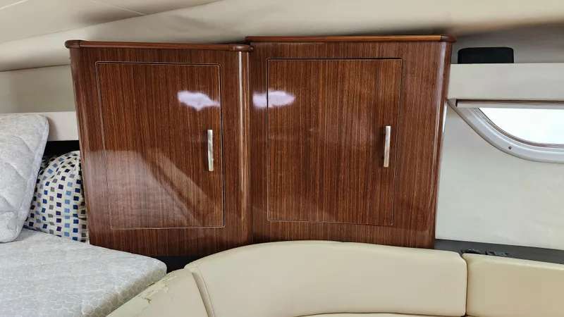 Slide: The Image of 2014 Regal 35 Sport Coupe interior with wooden cabinets and cozy seating. - 27