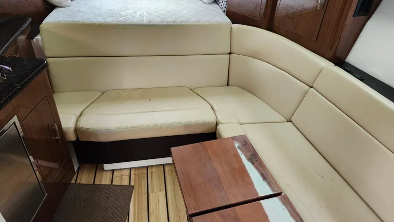 Slide: The Image of Interior of 2014 Regal 35 Sport Coupe with beige seating and wooden accents. - 28