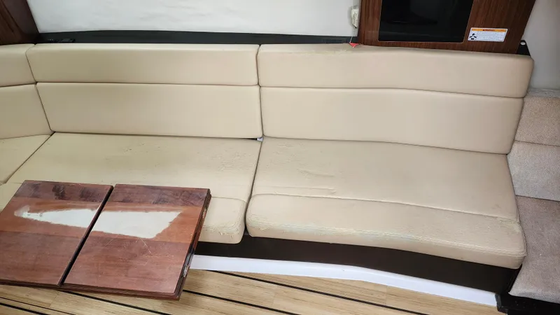 Slide: The Image of Beige leather seating and wooden table inside 2014 Regal 35 Sport Coupe boat. - 29