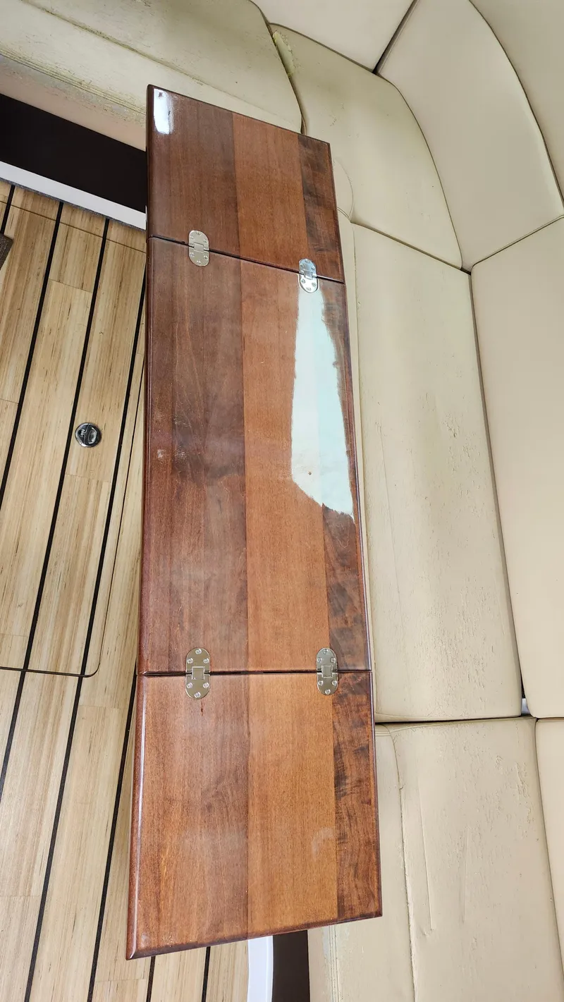 Slide: The Image of Wooden table with hinges on a Regal 35 Sport Coupe 2014 boat interior. - 31