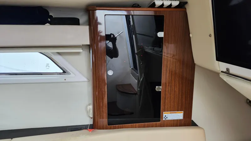 Slide: The Image of Interior of a 2014 Regal 35 Sport Coupe with wooden cabinetry and window view. - 32