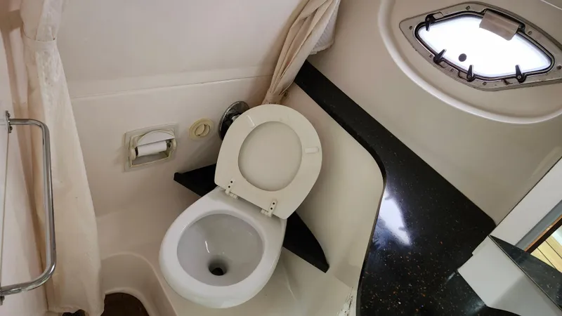 Slide: The Image of Bathroom interior of 2014 Regal 35 Sport Coupe with toilet and porthole window. - 38