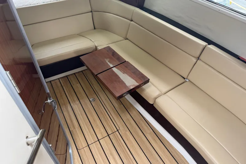 Slide: The Image of 2014 Regal 35 Sport Coupe yacht docked at marina, featuring sleek design and modern amenities. - 5