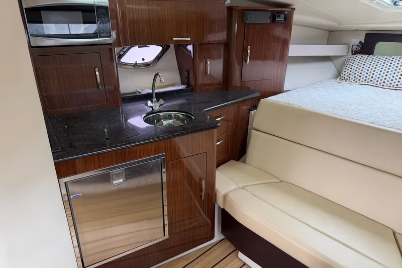Slide: The Image of 2014 Regal 35 Sport Coupe cockpit with steering wheel, navigation screens, and control panel. - 6