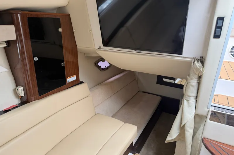 Slide: The Image of 2014 Regal 35 Sport Coupe cockpit with Garmin navigation and beige seating. - 8