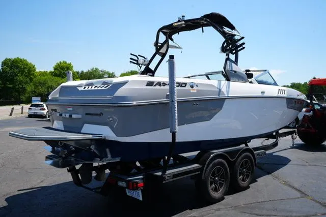 Slide: The Image of 2016 Supra SA400-550 boat on trailer, parked outdoors, with trees in the background. - 3