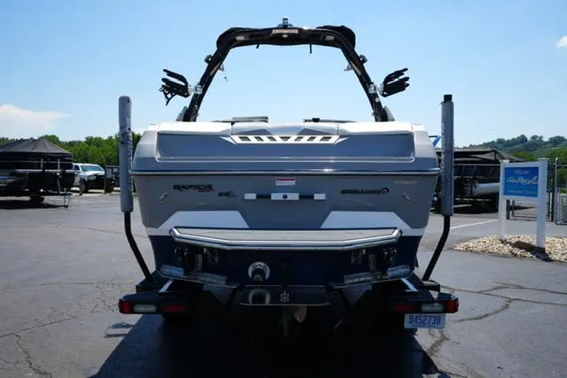 Slide: The Image of 2016 Supra SA400-550 boat, rear view, parked on pavement with clear sky background. - 4