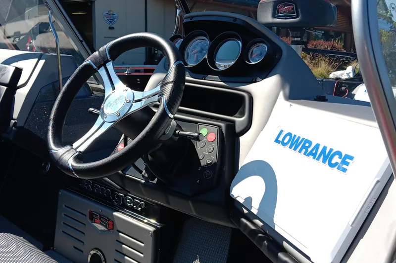 Slide: The Image of 2025 Ranger 620FS Cup Equipped boat dashboard with steering wheel and Lowrance electronics. - 2
