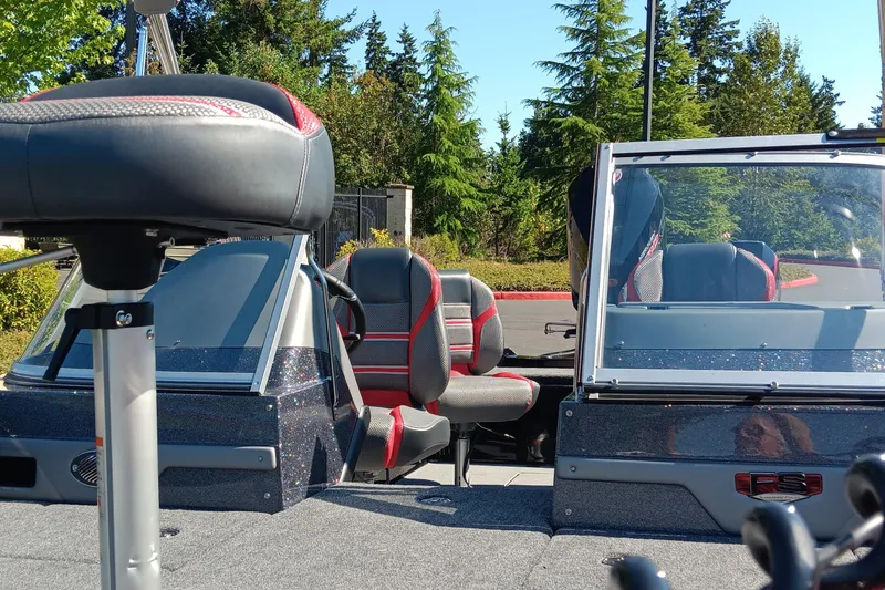 Slide: The Image of 2025 Ranger 620FS Cup Equipped boat interior with seating and windshield, surrounded by trees. - 4